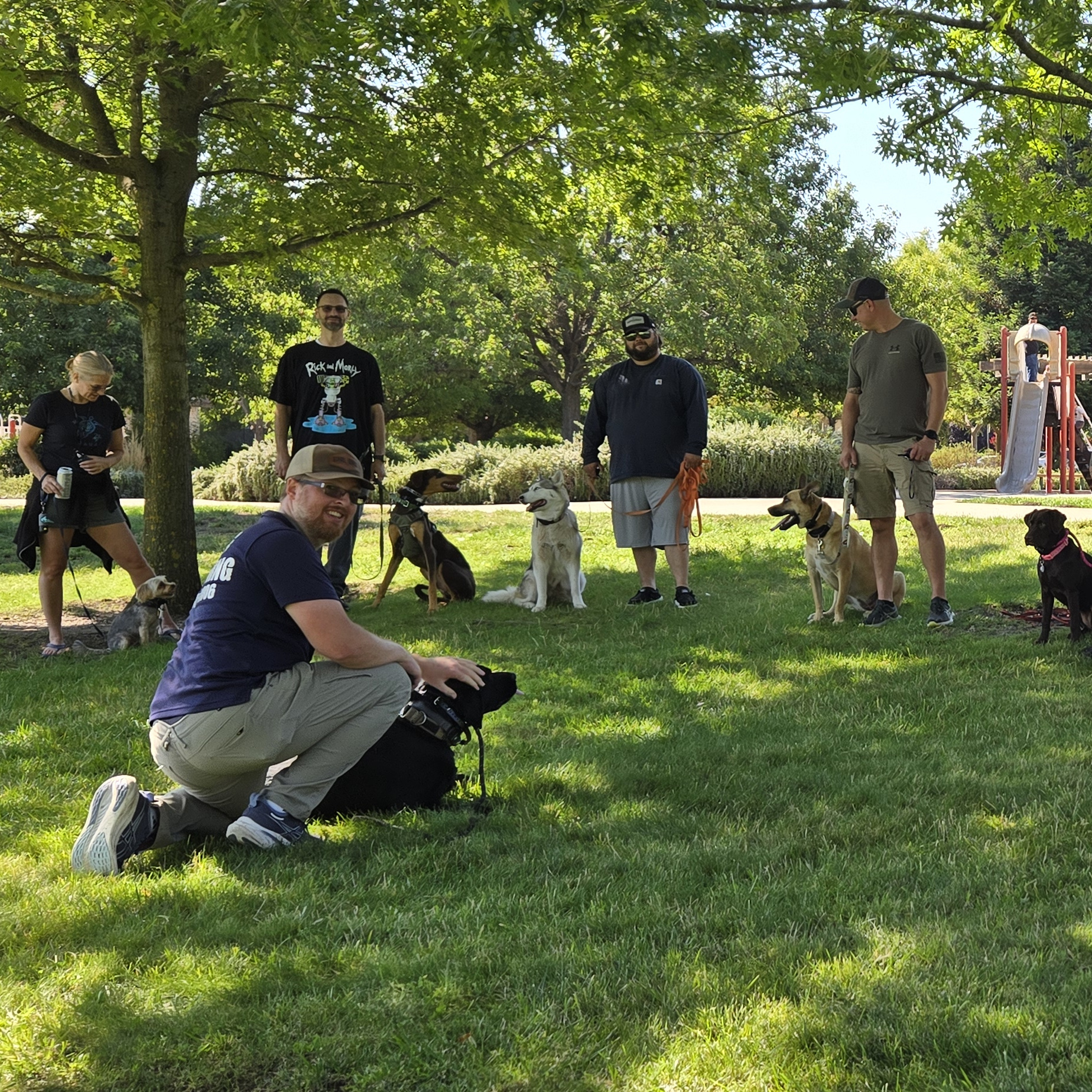 Chris from WUDOG training dogs at a local park with owners